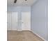 A charming bedroom with blue walls and two white paneled doors provides ample storage at 1501 Palmina Loop # B, Myrtle Beach, SC 29588