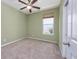 The bedroom has a neutral carpet, light green walls, a ceiling fan, and a window that lets in natural light at 1501 Palmina Loop # B, Myrtle Beach, SC 29588