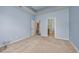Cozy bedroom with tray ceilings, neutral carpet, and entryways to a bathroom and closet at 1501 Palmina Loop # B, Myrtle Beach, SC 29588