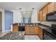 The kitchen boasts granite countertops, a breakfast bar, and black appliances at 1501 Palmina Loop # B, Myrtle Beach, SC 29588