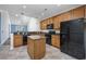 Open-concept kitchen featuring granite countertops, island, and modern black appliances at 1501 Palmina Loop # B, Myrtle Beach, SC 29588