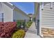 Charming side yard with manicured garden and iron gate leading to the backyard at 1501 Palmina Loop # B, Myrtle Beach, SC 29588