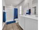 Well-lit bathroom with double sink vanity, vinyl floors, and a stand up shower with blue accents at 156 Teddy Bear Circle, Conway, SC 29526