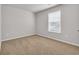 Empty bedroom features plush carpet, white walls, and a window at 156 Teddy Bear Circle, Conway, SC 29526