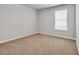 Bright bedroom featuring a large window providing natural light and neutral walls and carpet at 156 Teddy Bear Circle, Conway, SC 29526