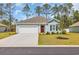 Charming single-story home with a manicured lawn, concrete driveway, and a vibrant red front door at 156 Teddy Bear Circle, Conway, SC 29526