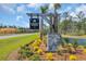 Auberon Woods West community sign with lush landscaping and a glimpse of the lake at 156 Teddy Bear Circle, Conway, SC 29526