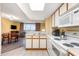 Efficient kitchen with white cabinetry and appliances, opening to the dining and living areas at 1604 N Ocean Blvd. # 904, Myrtle Beach, SC 29577