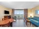 Cozy living room with a large window to the balcony with a view, comfortable seating, and a TV at 1604 N Ocean Blvd. # 904, Myrtle Beach, SC 29577