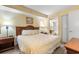 Inviting bedroom with a comfortable bed, soft lighting, and a doorway to the bathroom at 1604 N Ocean Blvd. # 904, Myrtle Beach, SC 29577