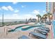 Outdoor pool area with lounge chairs, tables, and lush landscaping at 1604 N Ocean Blvd. # 904, Myrtle Beach, SC 29577