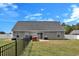 Well-maintained backyard features a black metal fence, grill, and lush green grass at 1794 Graham Rd., Aynor, SC 29544