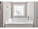 Bathroom featuring a white bathtub, a window and a door to the outside at 1794 Graham Rd., Aynor, SC 29544