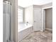 Bright bathroom featuring a built-in bathtub with shower, white tile, and a window for natural light at 1794 Graham Rd., Aynor, SC 29544