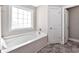 Bathroom featuring a white bathtub, a window and a door to the outside at 1794 Graham Rd., Aynor, SC 29544