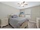 This bedroom is illuminated by natural light from the window, complemented by a ceiling fan at 1794 Graham Rd., Aynor, SC 29544