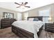 Spacious bedroom with a large bed, wood floor, ceiling fan, two bedside tables and a mirror at 1794 Graham Rd., Aynor, SC 29544