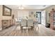 Open dining area featuring wood-look floors, neutral walls, and natural light from the large window at 1794 Graham Rd., Aynor, SC 29544