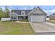 Charming one-story home featuring gray siding, a well-manicured lawn, and an attached two-car garage at 1794 Graham Rd., Aynor, SC 29544