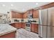 Modern kitchen with stainless steel appliances, granite countertops, and dark wood cabinets at 1794 Graham Rd., Aynor, SC 29544