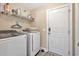 Bright laundry room featuring a washer and dryer, wire shelving, and durable flooring at 1794 Graham Rd., Aynor, SC 29544