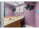 Charming bathroom features a single sink vanity with wood cabinets and decorative fish accents on the walls at 1801 N Ocean Blvd. # O-4, North Myrtle Beach, SC 29582