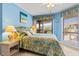 Relaxing bedroom features a full bed, a balcony view, and tropical-themed décor at 1801 N Ocean Blvd. # O-4, North Myrtle Beach, SC 29582