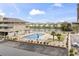 Community pool and lake offering a relaxing outdoor space with lounge chairs and lush landscaping at 1801 N Ocean Blvd. # O-4, North Myrtle Beach, SC 29582