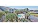 Inviting aerial view of condos overlooking a pristine pool, hot tub, and pond at 1891 Colony Dr. # 15E, Surfside Beach, SC 29575