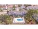 Scenic aerial view of condos overlooking a pristine pool and a tranquil pond at 1891 Colony Dr. # 15E, Surfside Beach, SC 29575