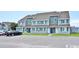 Attractive condo featuring blue shutters, gray paint, and parking in front of each unit at 1891 Colony Dr. # 15E, Surfside Beach, SC 29575