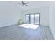 Bright living room featuring wood-look floors, a ceiling fan, and a sliding glass door to a patio at 1891 Colony Dr. # 15E, Surfside Beach, SC 29575