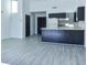 Open floor plan showcasing wood-look flooring, bar seating, and access to the kitchen at 1891 Colony Dr. # 15E, Surfside Beach, SC 29575