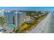 Picturesque beachside condo complex with stunning pool, ocean views, and palm trees at 200 76Th Ave. N # 1211, Myrtle Beach, SC 29572