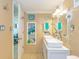 Well-lit bathroom featuring double sinks, a large mirror, and ample storage space at 200 76Th Ave. N # 1211, Myrtle Beach, SC 29572