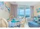 Dining area with four chairs that is adjacent to the outdoor balcony and the living room at 200 76Th Ave. N # 1211, Myrtle Beach, SC 29572