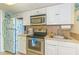 Efficient kitchen featuring stainless steel appliances and white cabinetry at 200 76Th Ave. N # 1211, Myrtle Beach, SC 29572