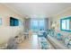 Bright living space with sliding glass doors, wicker furnishings, and ocean views at 200 76Th Ave. N # 1211, Myrtle Beach, SC 29572