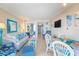 Open-concept living room with comfortable seating and sliding door to a balcony at 200 76Th Ave. N # 1211, Myrtle Beach, SC 29572