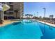Inviting and refreshing pool featuring ample lounging chairs and palm trees at 200 76Th Ave. N # 1211, Myrtle Beach, SC 29572