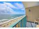 Relax on the balcony overlooking a beautiful beach with turquoise water and a bright, sunny sky at 201 74Th Ave. N # 1128, Myrtle Beach, SC 29572