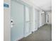 Hallway of condo building showing unit door with digital lock and window to the living area at 201 74Th Ave. N # 1128, Myrtle Beach, SC 29572