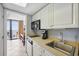 This kitchenette boasts white cabinetry, a stainless sink, and a microwave oven for efficient cooking at 201 74Th Ave. N # 1128, Myrtle Beach, SC 29572