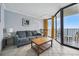 This living room features a sofa, a coffee table, balcony access, and neutral tones for relaxation at 201 74Th Ave. N # 1128, Myrtle Beach, SC 29572