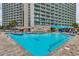 An outdoor swimming pool with blue water in front of a condo building with multiple floors at 201 74Th Ave. N # 1128, Myrtle Beach, SC 29572