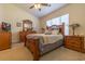 Comfortable bedroom featuring a ceiling fan, window with blinds, and wood furniture set at 221 Port Smith Dr. # 6, Myrtle Beach, SC 29588