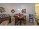 Cozy dining area with a wooden table set for four, complemented by decorative wall art at 221 Port Smith Dr. # 6, Myrtle Beach, SC 29588