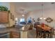 Open-concept living space with kitchen bar, dining area, and living room with sliding glass doors at 221 Port Smith Dr. # 6, Myrtle Beach, SC 29588