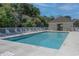 Community pool area with lounge chairs, a fence, and a nearby building with a covered area at 221 Port Smith Dr. # 6, Myrtle Beach, SC 29588