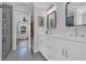 Bathroom boasts double sinks, white cabinetry, and an open doorway to a bedroom with bunk beds at 2309 Seaseeker Ln., Myrtle Beach, SC 29577